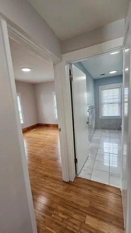 a view of a room with wooden floor and staircase