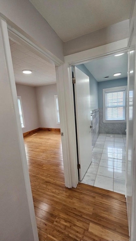 90 Wallace Street, Unit 2 Somerville, MA 02144 - Photo 11 of 17 a view of a room with wooden floor and staircase