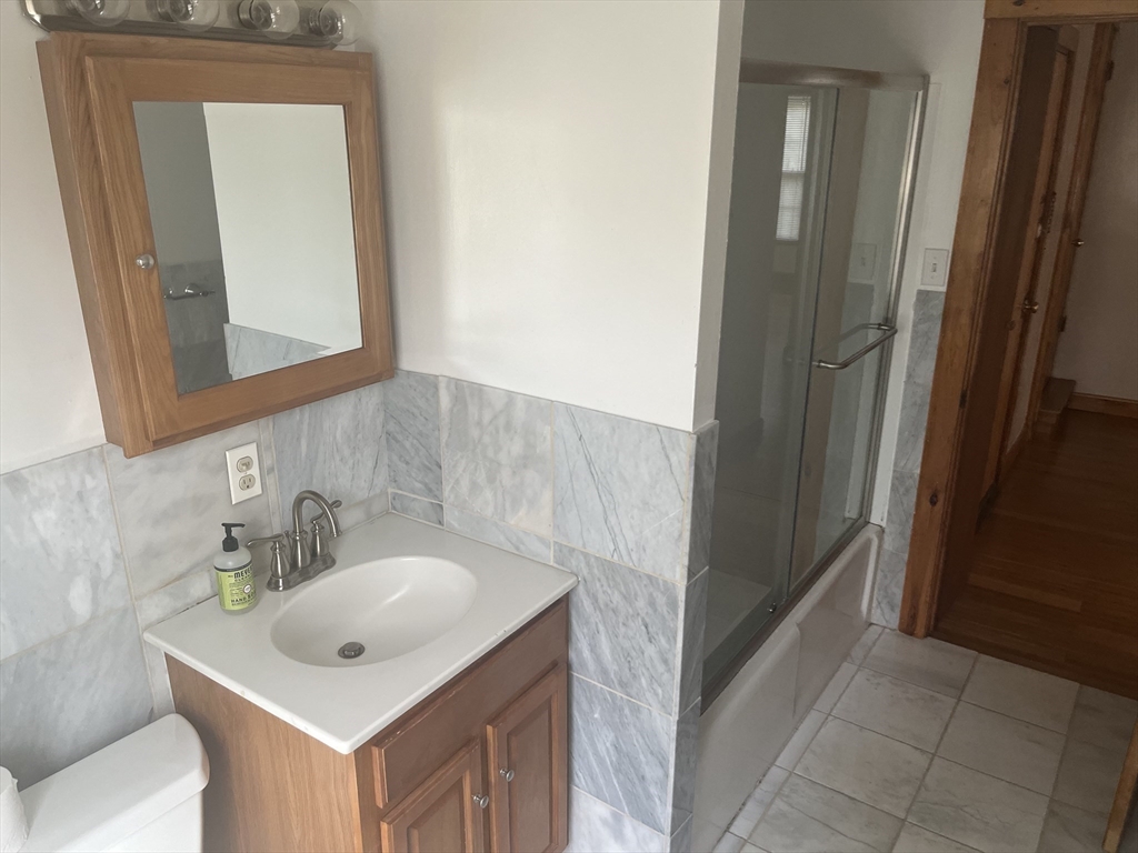 90 Wallace Street, Unit 2 Somerville, MA 02144 - Photo 13 of 17 a bathroom with a sink and a mirror