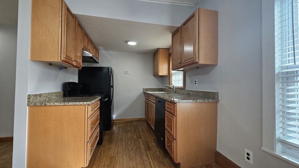 90 Wallace Street, Unit 2 Somerville, MA 02144 - Photo 3 of 17 a kitchen with stainless steel appliances granite countertop a stove a sink and a refrigerator