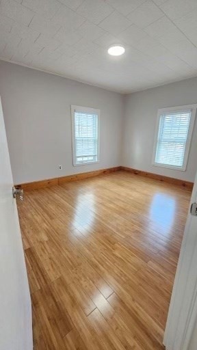 90 Wallace Street, Unit 2 Somerville, MA 02144 - Photo 8 of 17 an empty room with wooden floor and windows