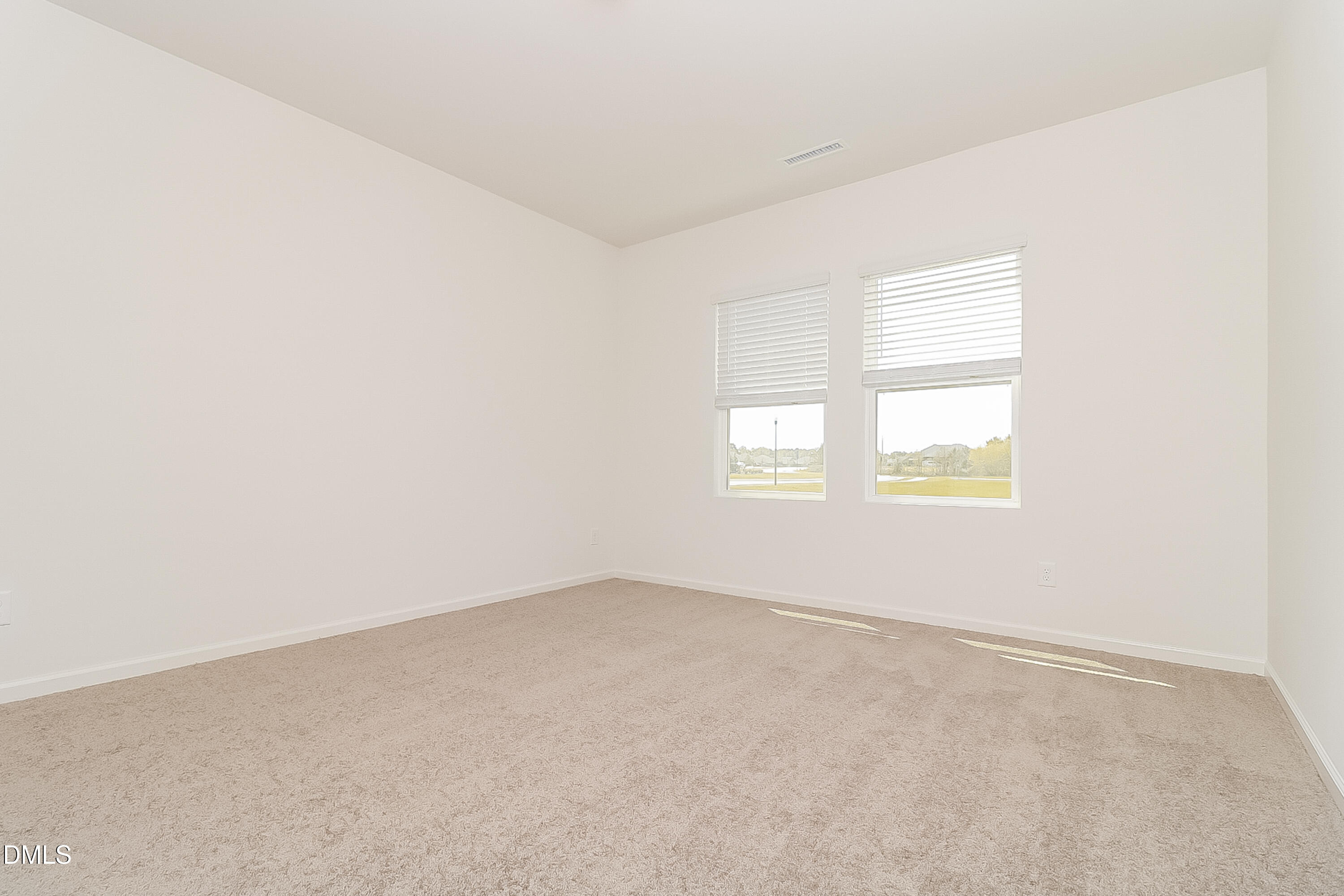 172 Ogden Pond Place Zebulon, NC 27597 - Photo 11 of 16 an empty room with windows