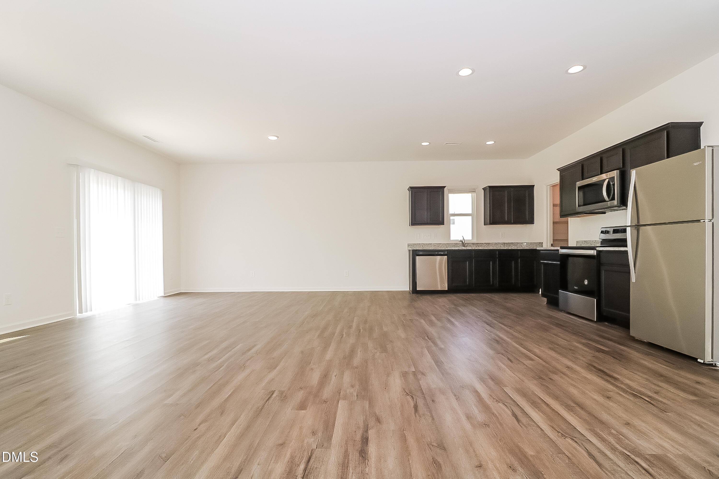 172 Ogden Pond Place Zebulon, NC 27597 - Photo 5 of 16 a view of kitchen with wooden floor and electronic appliances