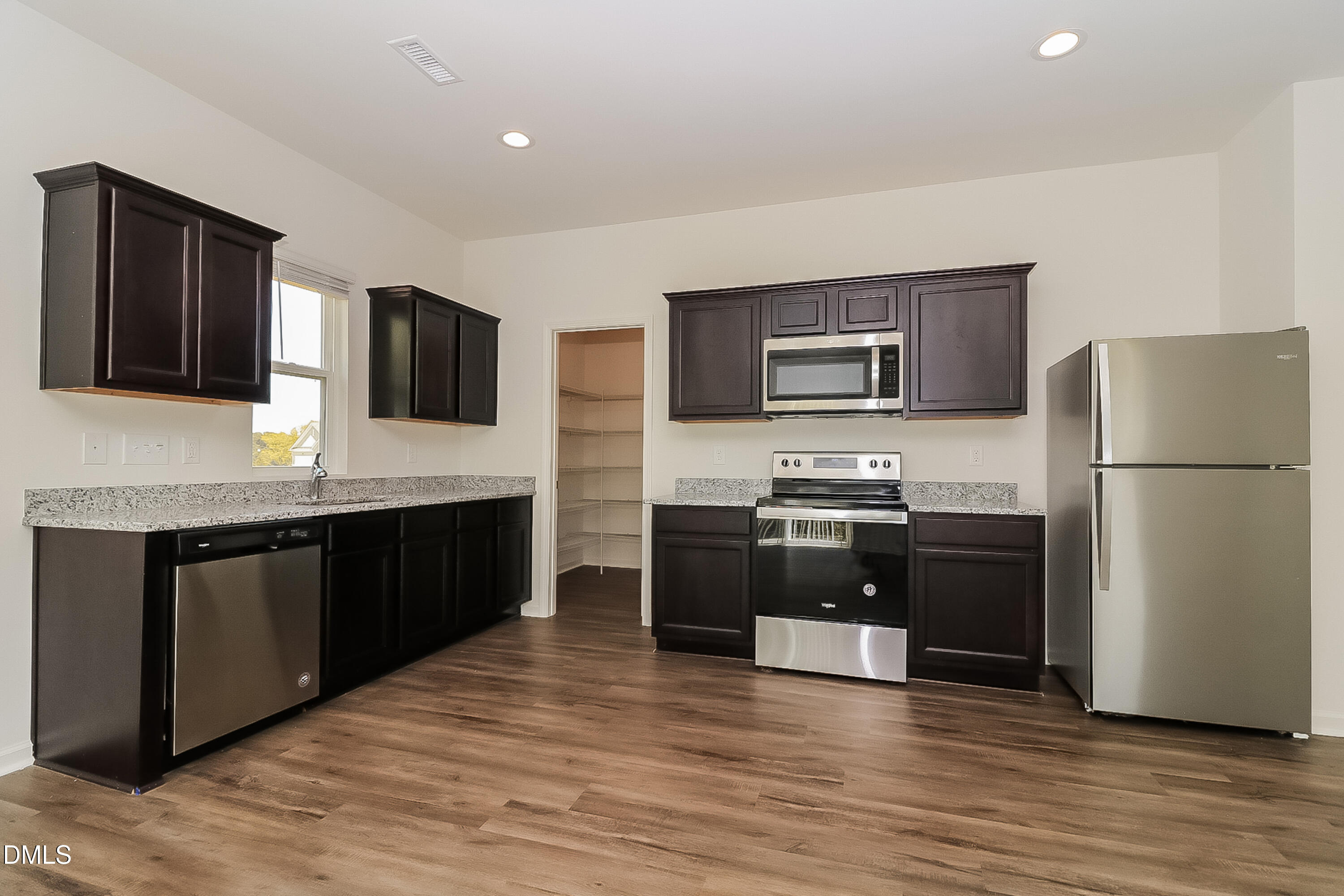 172 Ogden Pond Place Zebulon, NC 27597 - Photo 6 of 16 a kitchen with stainless steel appliances granite countertop a refrigerator and a stove top oven