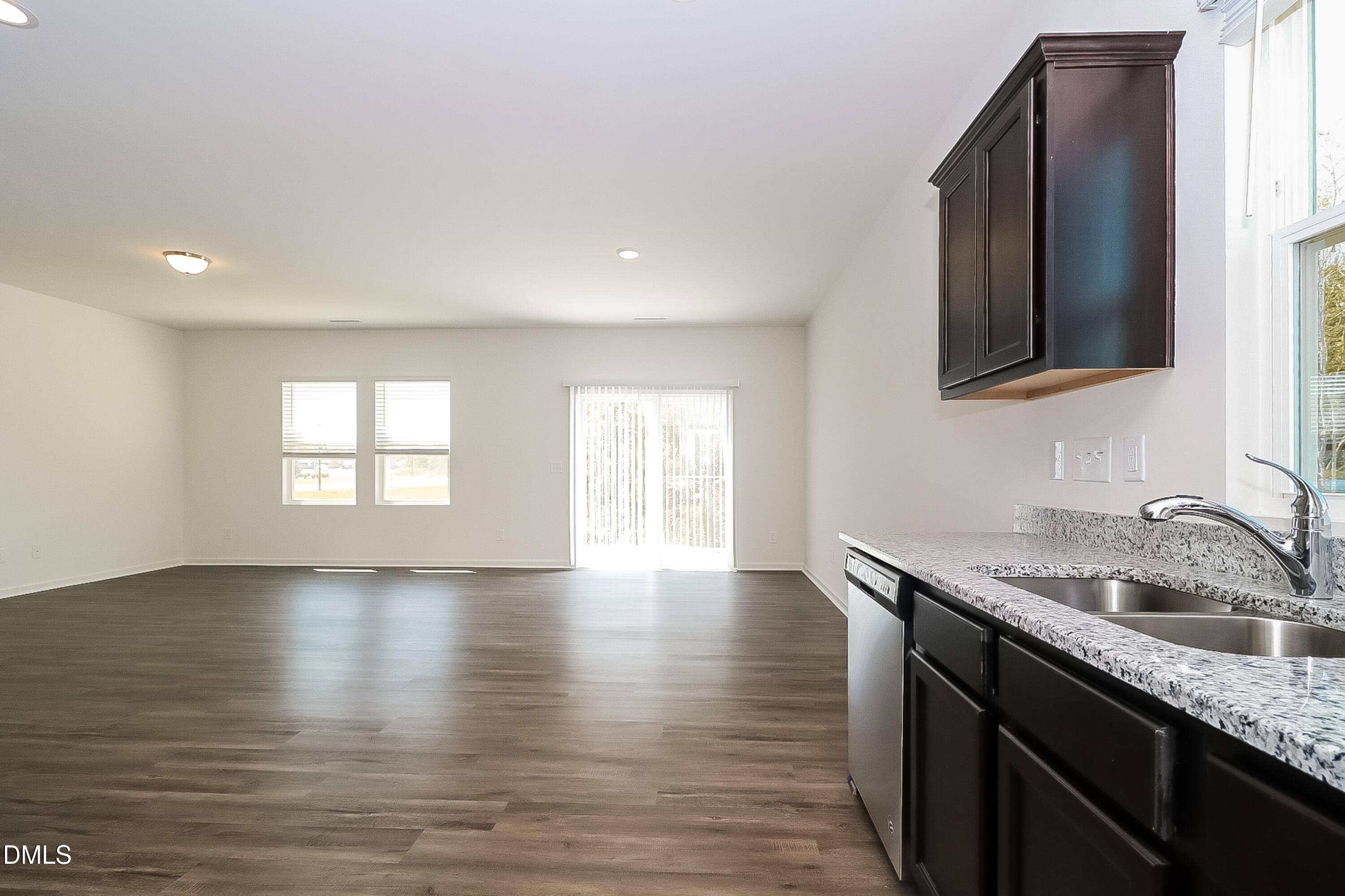 172 Ogden Pond Place Zebulon, NC 27597 - Photo 7 of 16 a kitchen with granite countertop a sink and a stove top oven