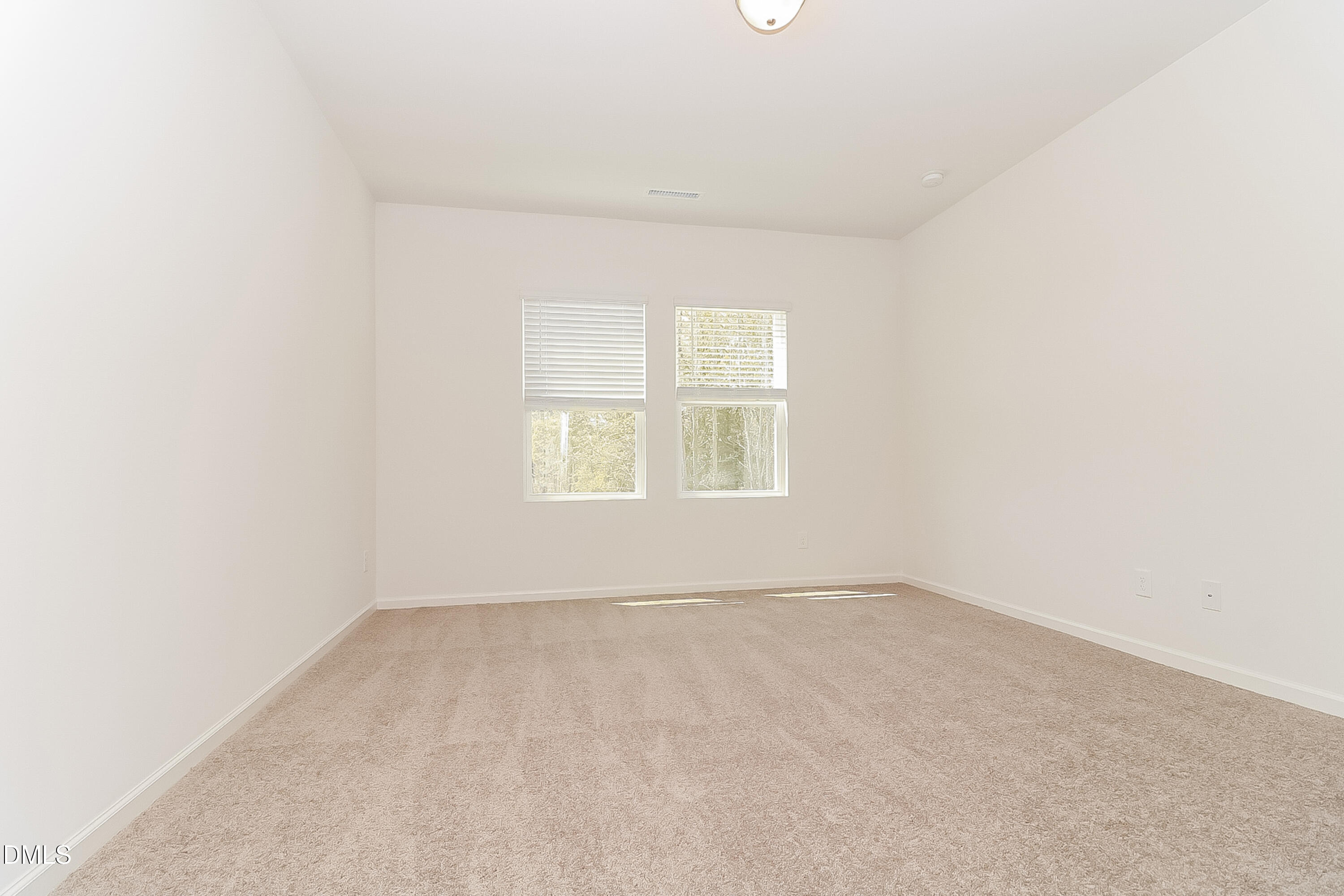 172 Ogden Pond Place Zebulon, NC 27597 - Photo 8 of 16 an empty room with a window