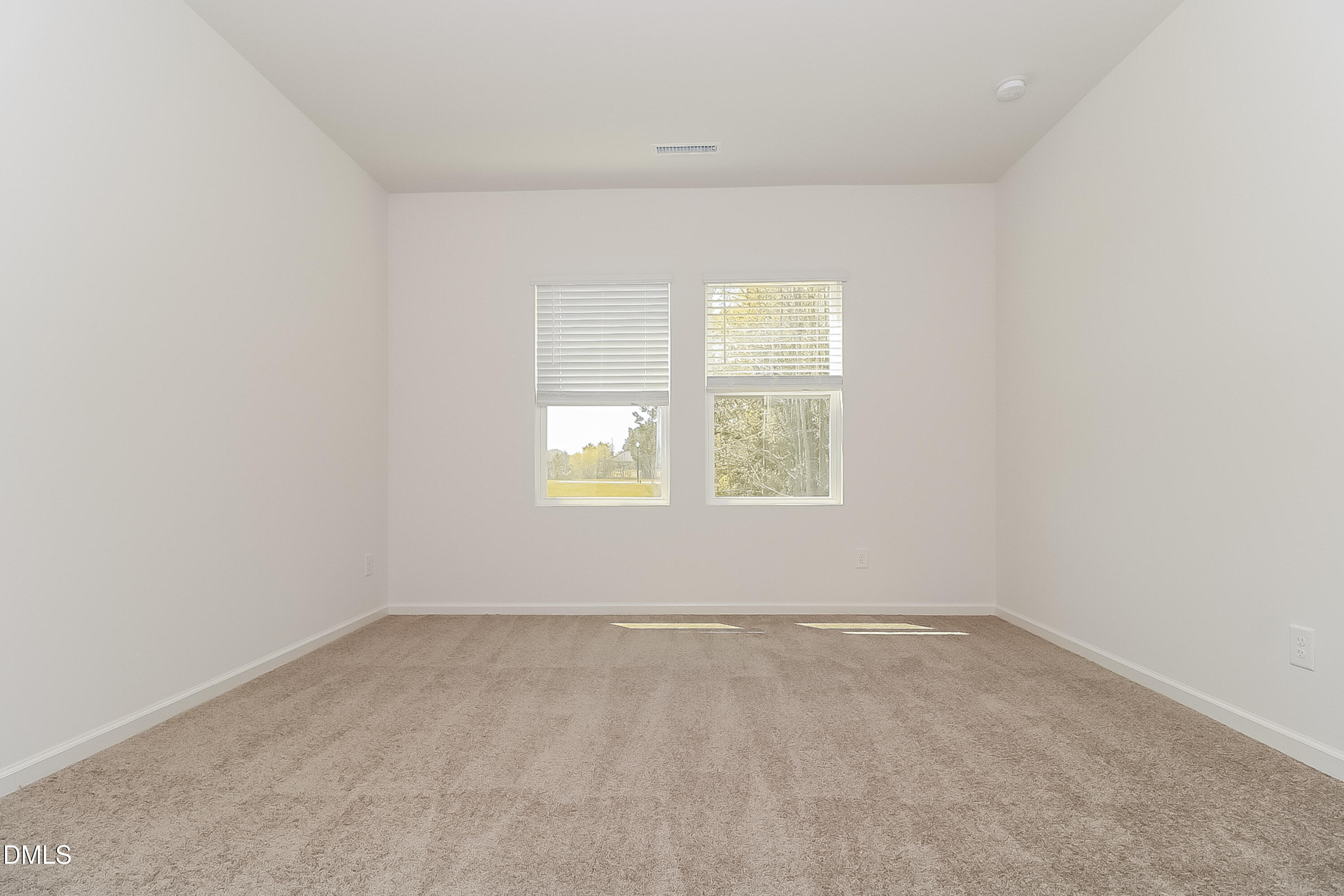 172 Ogden Pond Place Zebulon, NC 27597 - Photo 10 of 16 an empty room with a window