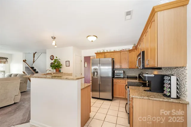 a kitchen with a refrigerator and a stove
