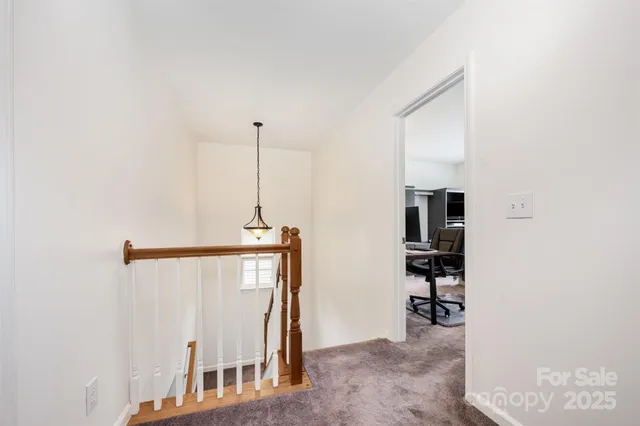 a view of a hallway with furniture