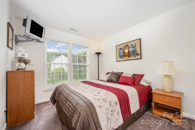 a bedroom with a bed and a couch