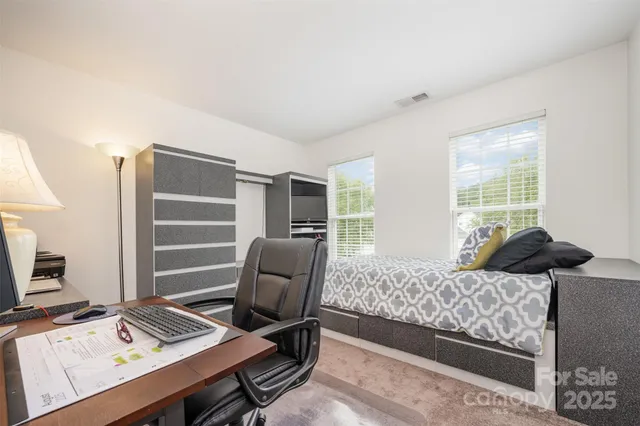 a bedroom with a bed and a desk