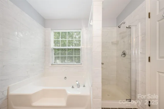 a bathroom with a bathtub and shower
