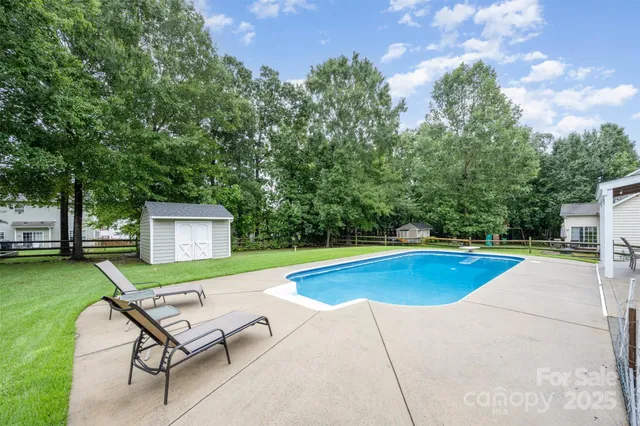 a view of a swimming pool with a lounge chair
