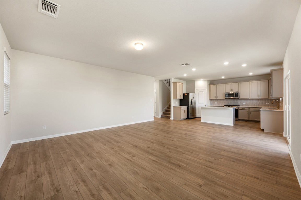 135 Silverleaf Spur Bastrop, TX 78602 - Photo 12 of 40 a view of kitchen with wooden floor and windows