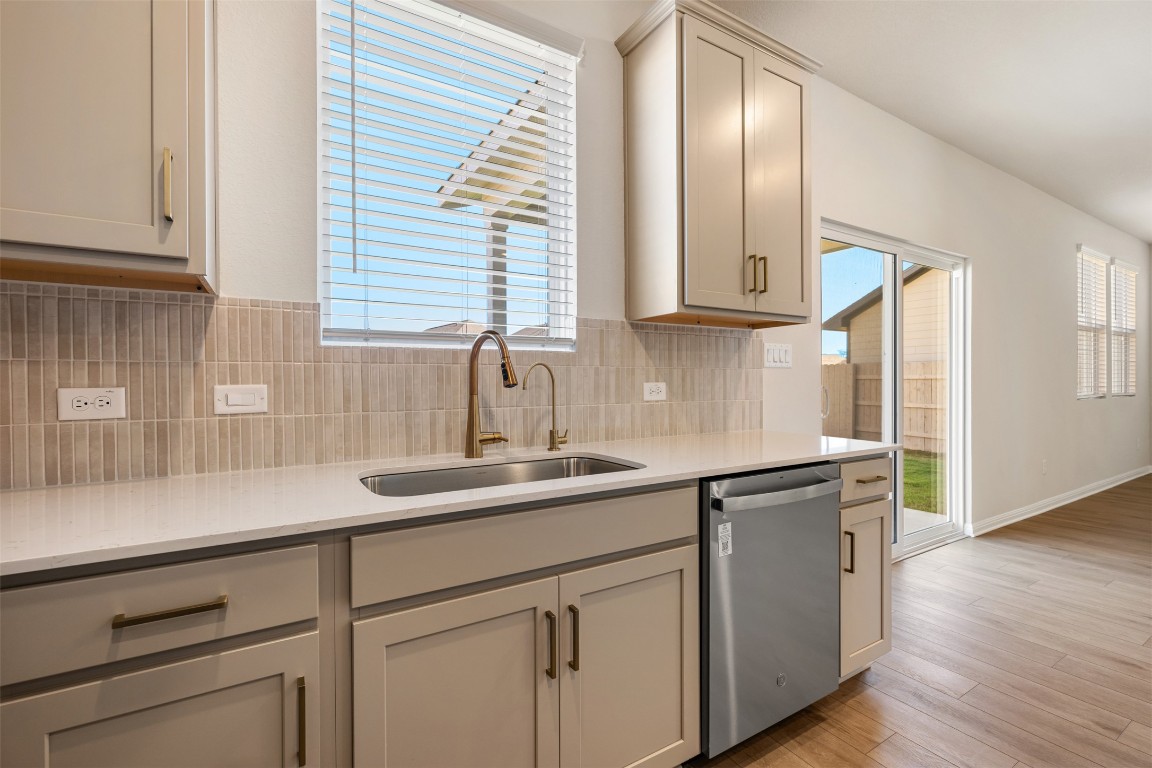 135 Silverleaf Spur Bastrop, TX 78602 - Photo 22 of 40 a kitchen with a sink and cabinets