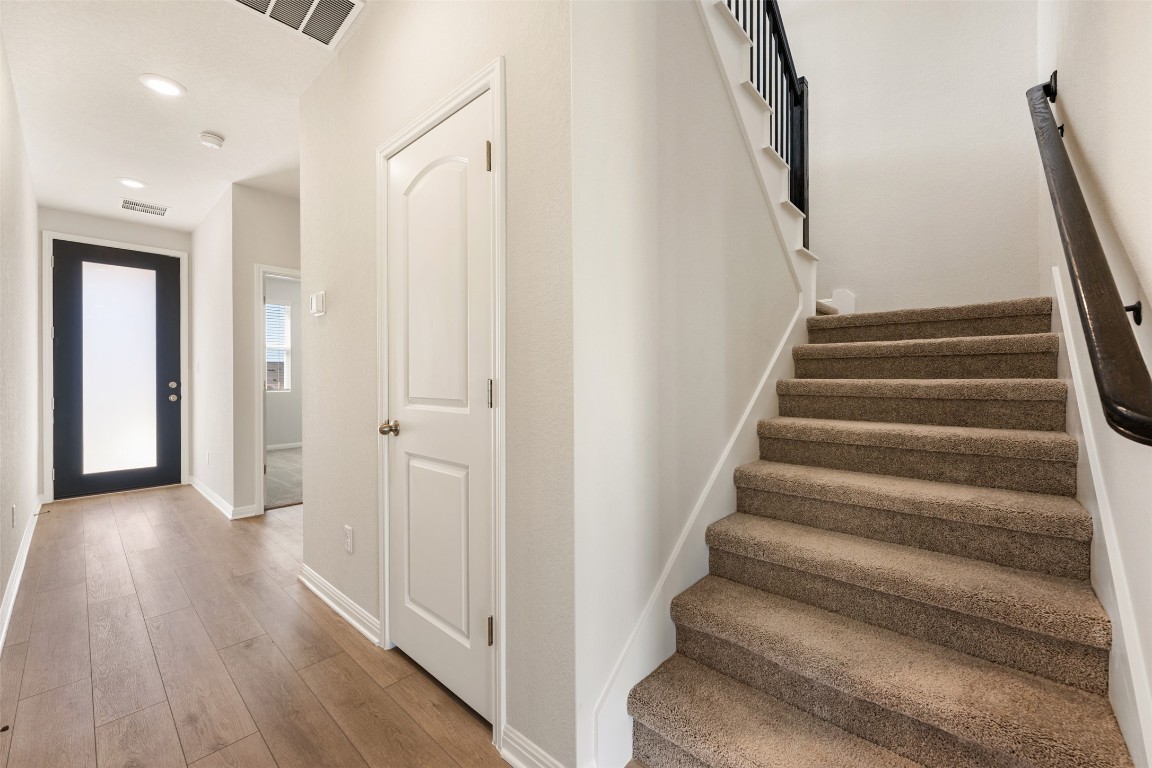 135 Silverleaf Spur Bastrop, TX 78602 - Photo 24 of 40 a view of a hallway with wooden floor and entryway