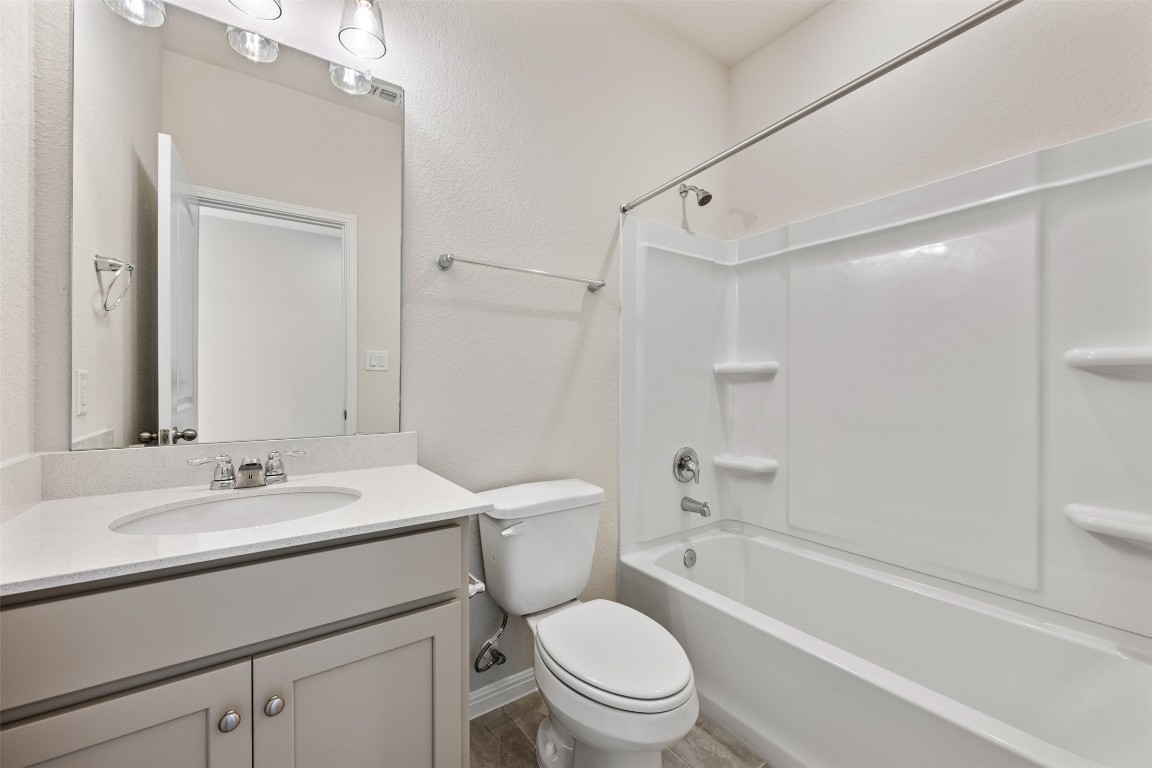 135 Silverleaf Spur Bastrop, TX 78602 - Photo 8 of 40 a bathroom with a sink toilet vanity tub and shower