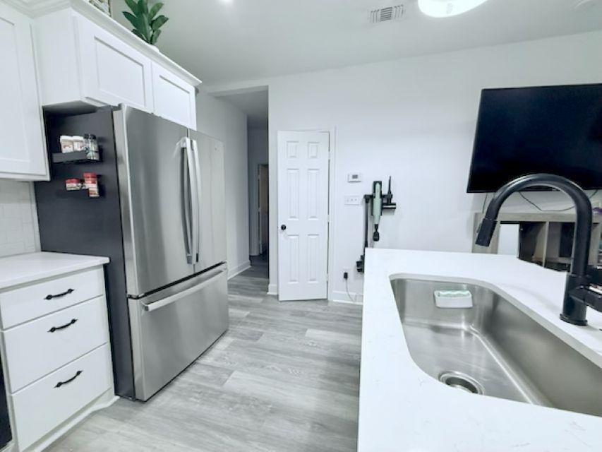 810 Brown Street Brenham, TX 77833 - Photo 12 of 36 a kitchen with stainless steel appliances granite countertop a refrigerator and a sink
