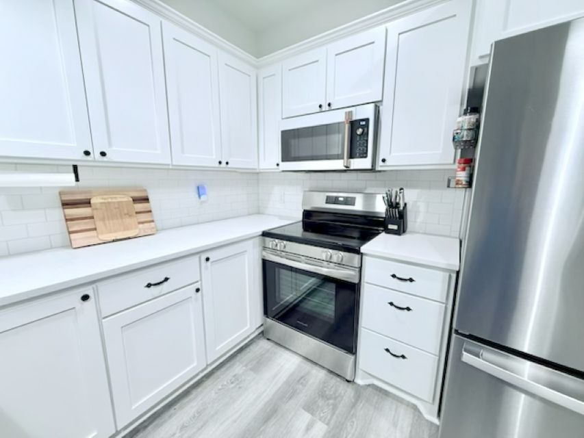 810 Brown Street Brenham, TX 77833 - Photo 13 of 36 a kitchen with stainless steel appliances white cabinets and a sink