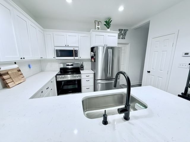 810 Brown Street Brenham, TX 77833 - Photo 14 of 36 a kitchen with granite countertop a refrigerator and a sink