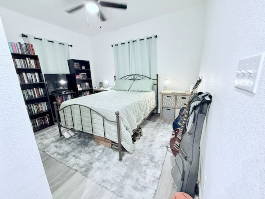 810 Brown Street Brenham, TX 77833 - Photo 16 of 36 a spacious bedroom with a bed and a walk in closet