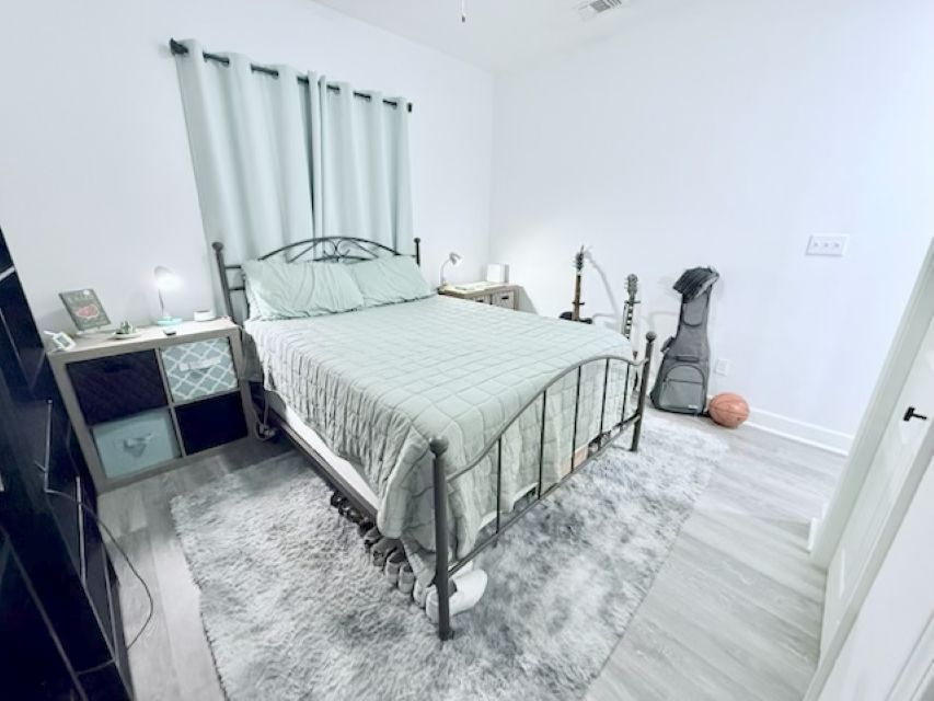 810 Brown Street Brenham, TX 77833 - Photo 17 of 36 a bedroom with a bed and a table