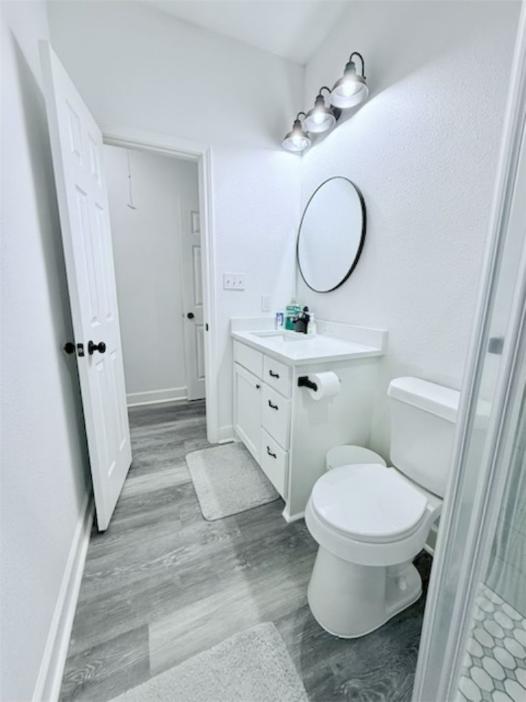 810 Brown Street Brenham, TX 77833 - Photo 19 of 36 a bathroom with a toilet sink and a mirror