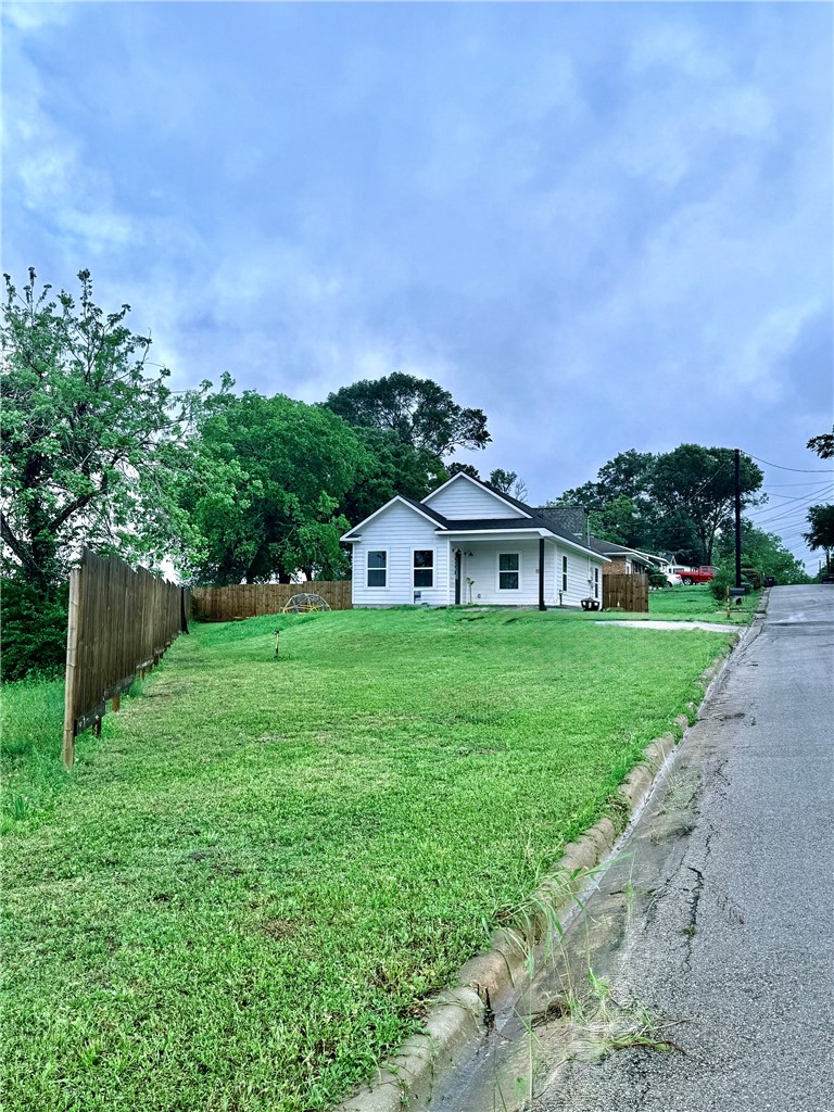 810 Brown Street Brenham, TX 77833 - Photo 33 of 36 a view of a house with a big yard plants and large trees