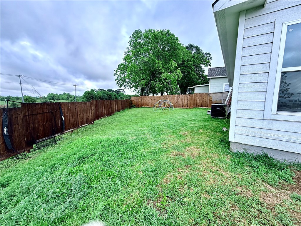 810 Brown Street Brenham, TX 77833 - Photo 36 of 36 a view of a backyard with plants and wooden fence