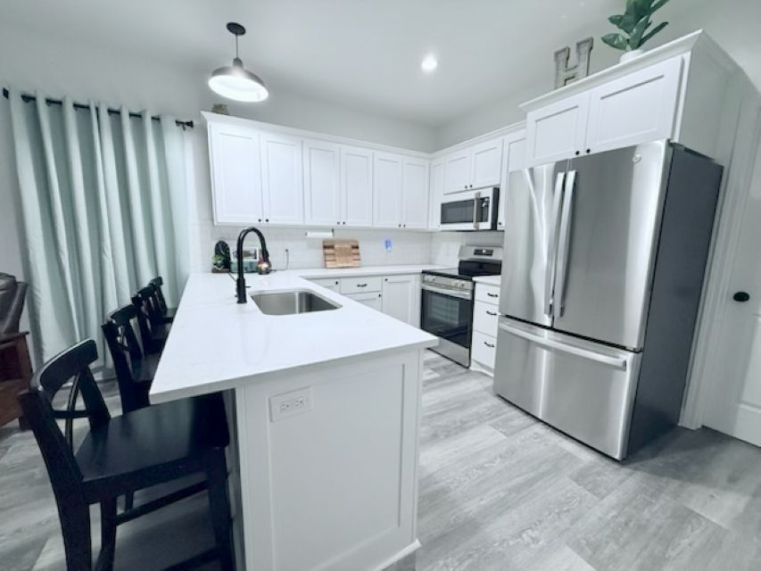 810 Brown Street Brenham, TX 77833 - Photo 8 of 36 a kitchen with refrigerator and chairs