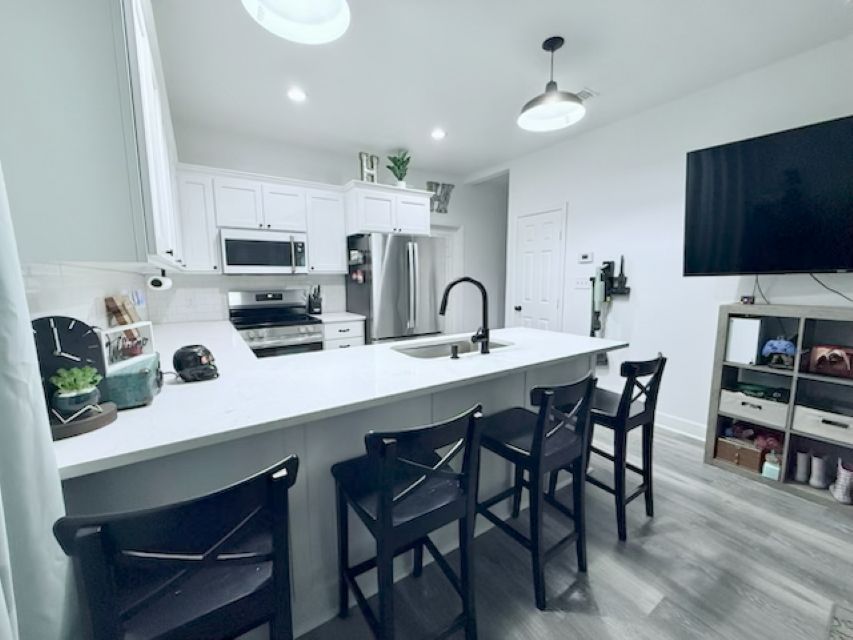 810 Brown Street Brenham, TX 77833 - Photo 9 of 36 a kitchen with kitchen island a dining table and chairs