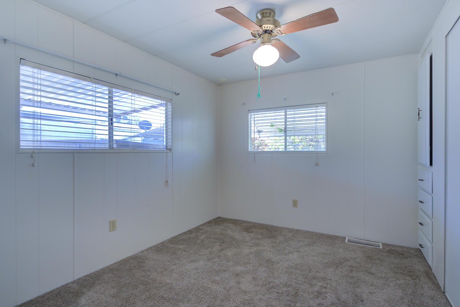172 Casa Grande Drive Red Bluff, CA 96080 - Photo 12 of 24 an empty room with windows and fan
