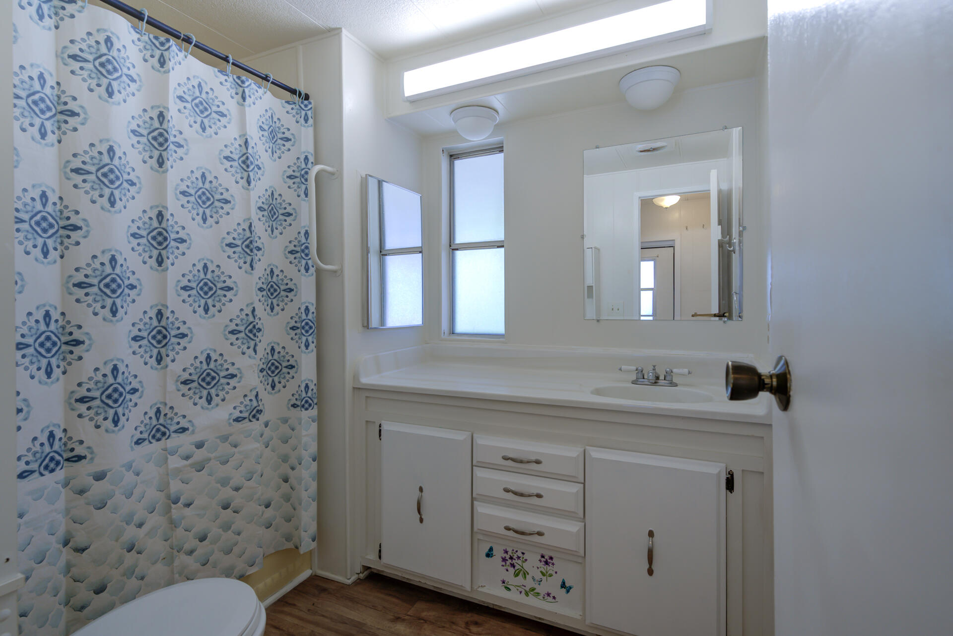 172 Casa Grande Drive Red Bluff, CA 96080 - Photo 14 of 24 a bathroom with a sink mirror vanity and toilet