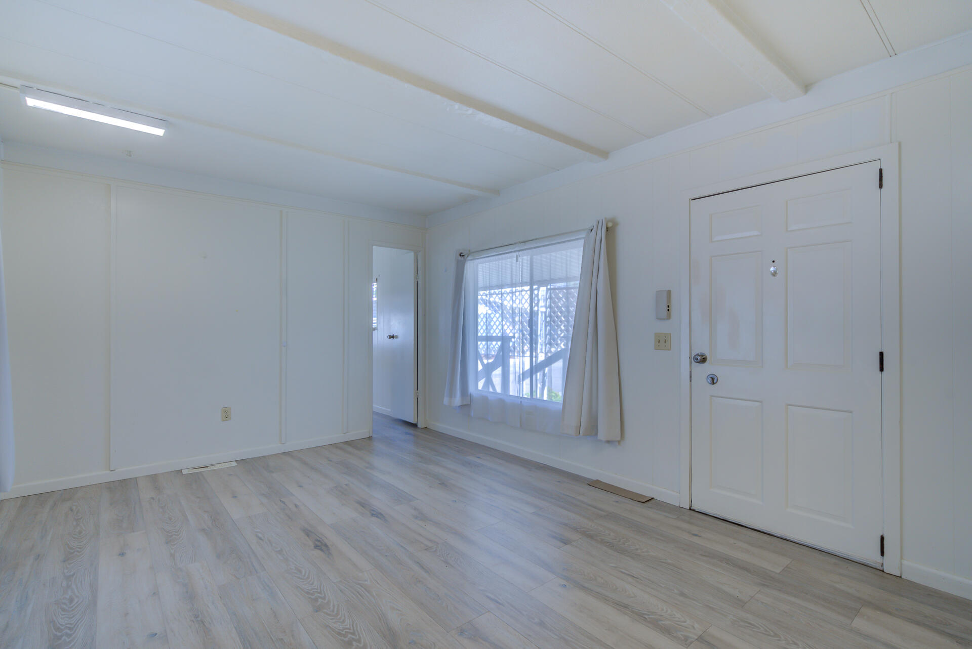 172 Casa Grande Drive Red Bluff, CA 96080 - Photo 2 of 24 a view of an empty room with wooden floor and a window
