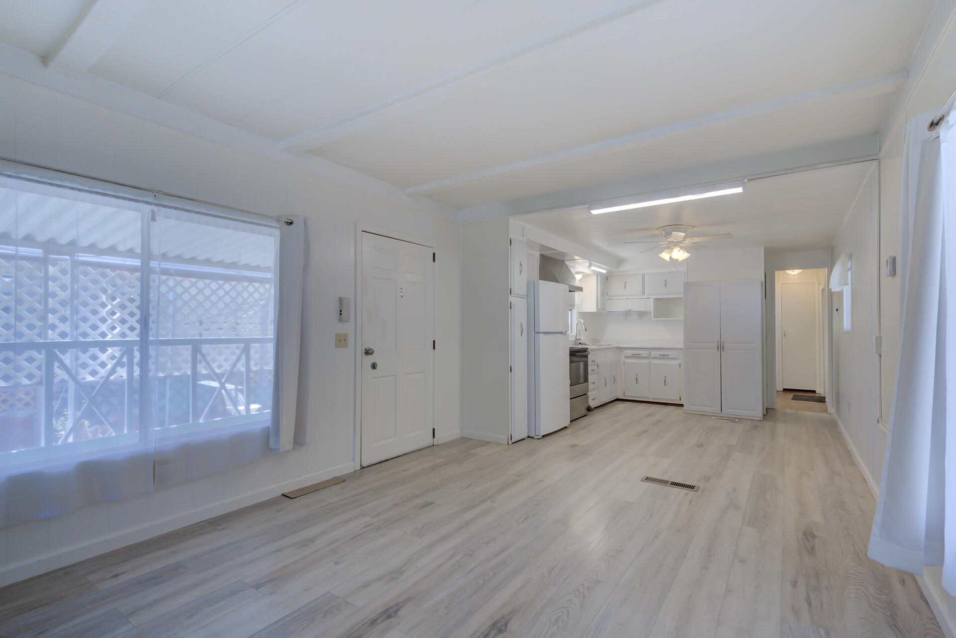 172 Casa Grande Drive Red Bluff, CA 96080 - Photo 3 of 24 a view of a big room with wooden floor and windows