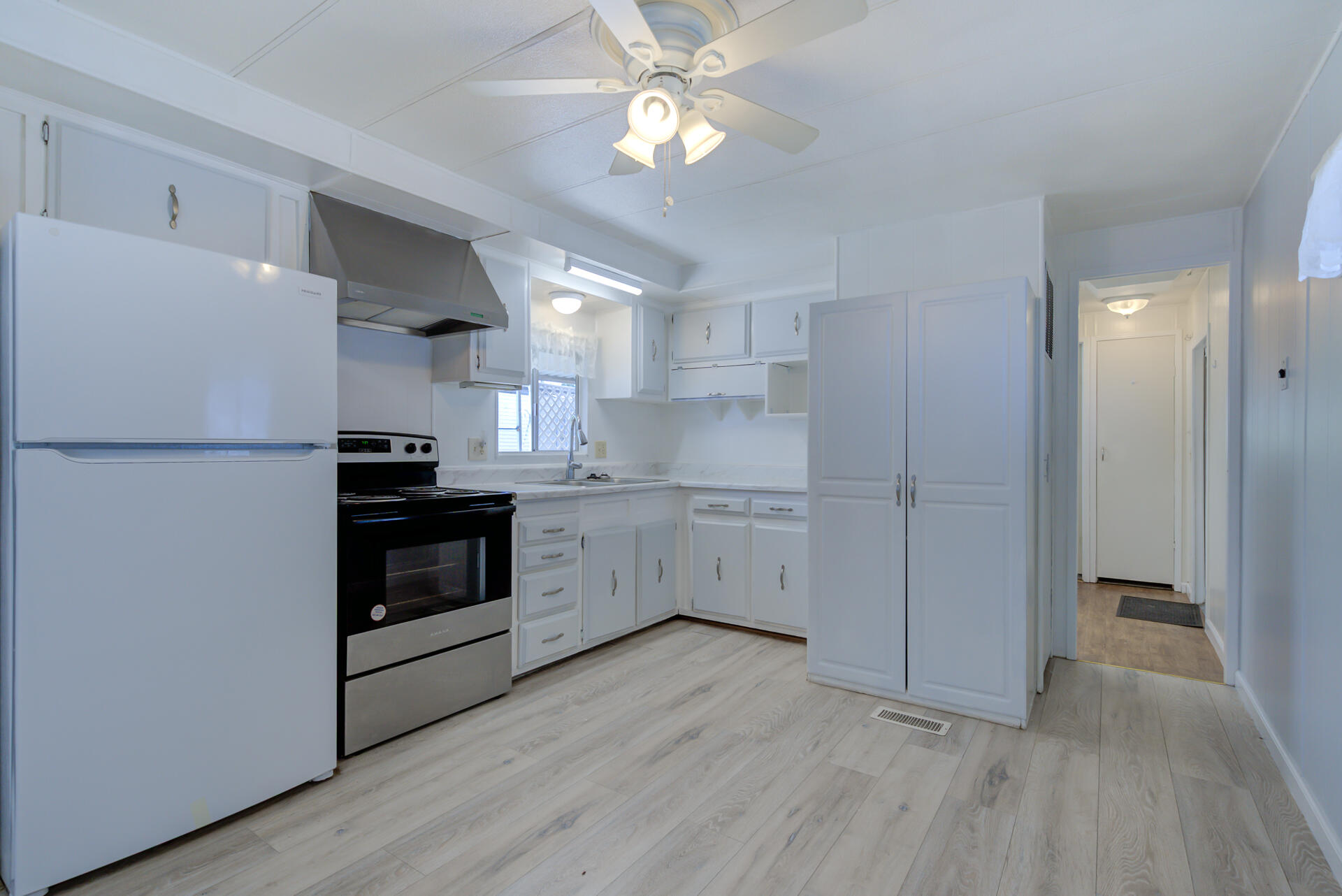 172 Casa Grande Drive Red Bluff, CA 96080 - Photo 7 of 24 a kitchen with a refrigerator and a stove top oven