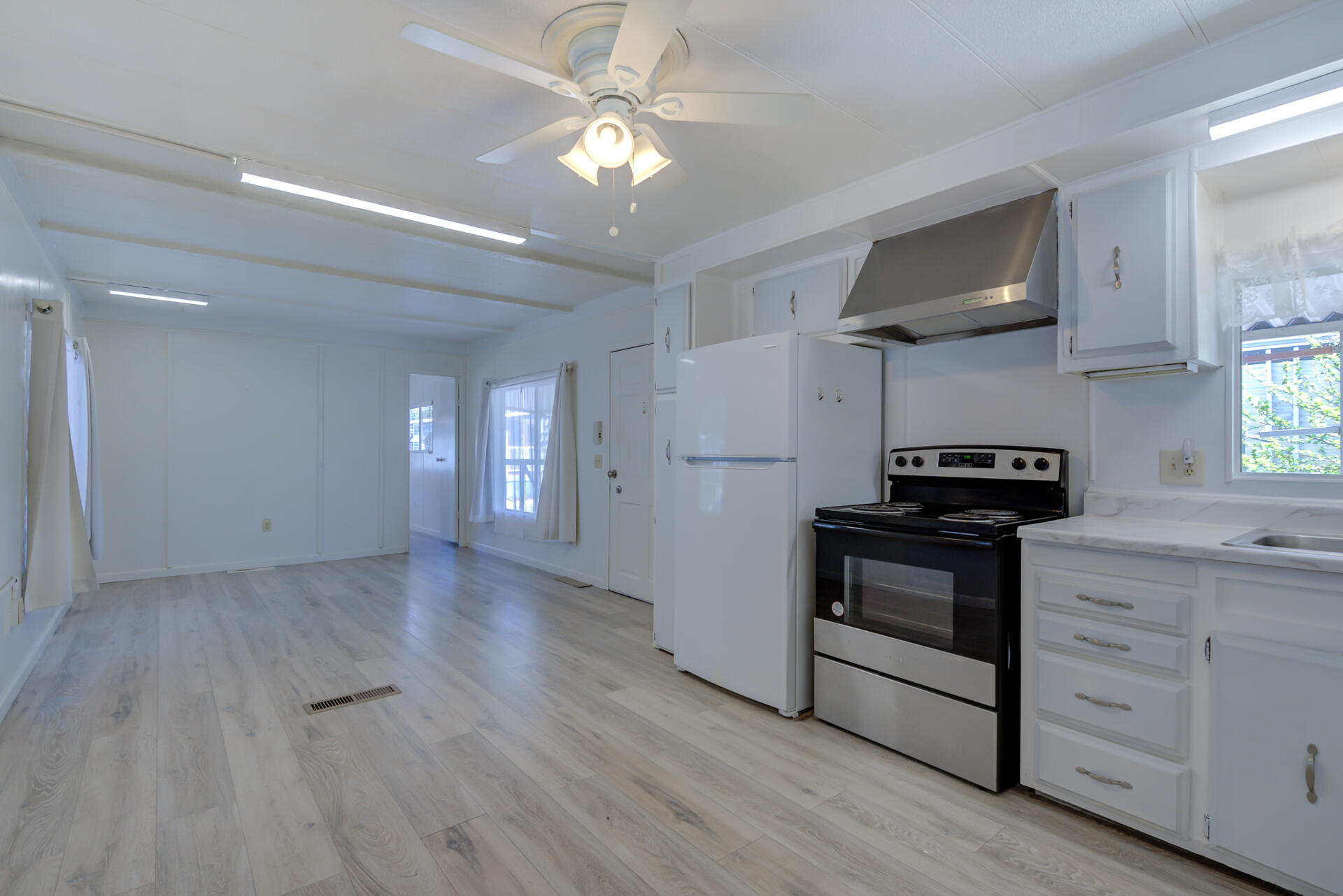 172 Casa Grande Drive Red Bluff, CA 96080 - Photo 9 of 24 a kitchen with granite countertop a stove cabinets and wooden floor