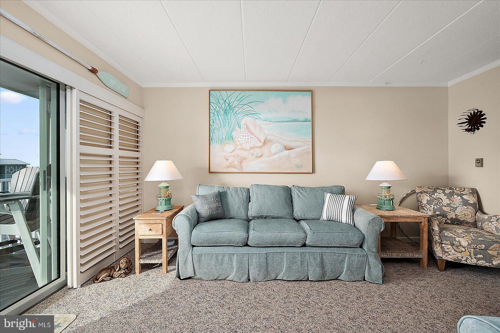 2 80th Street, Unit 504 Ocean City, MD 21842 - Photo 12 of 50 a living room with furniture and a lamp