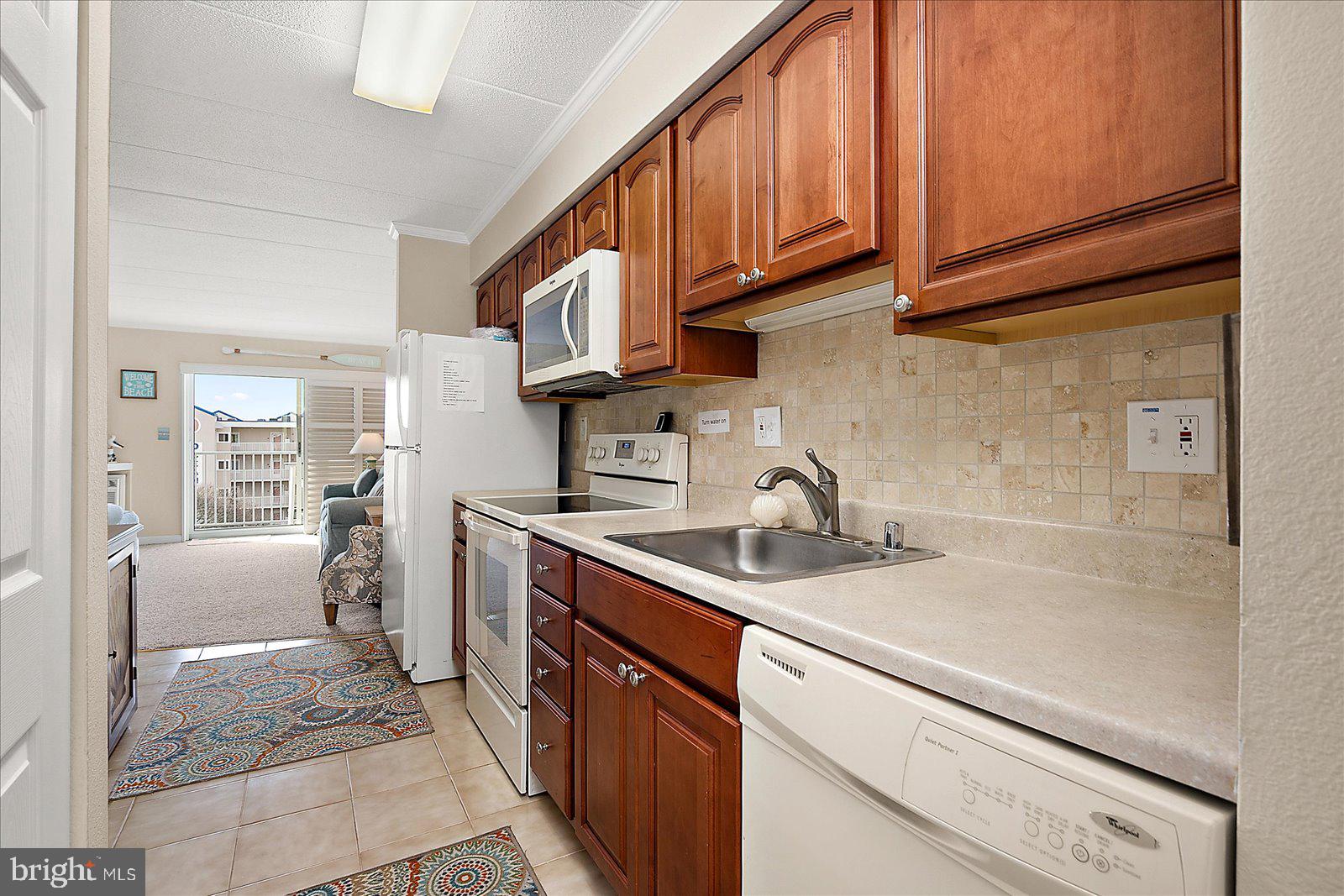 2 80th Street, Unit 504 Ocean City, MD 21842 - Photo 19 of 50 a kitchen with stainless steel appliances granite countertop a sink stove and cabinets
