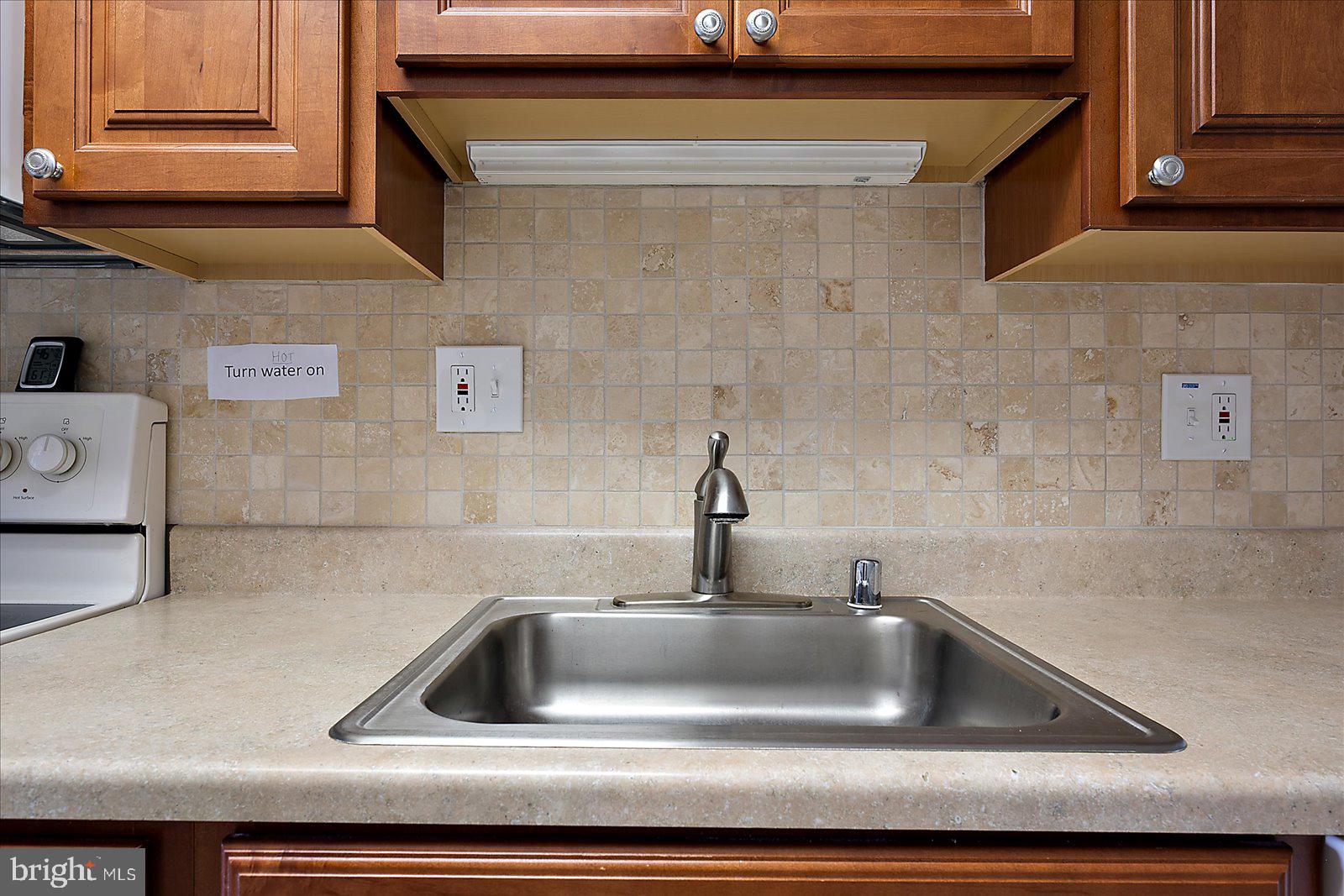 2 80th Street, Unit 504 Ocean City, MD 21842 - Photo 21 of 50 a kitchen with a sink and cabinets