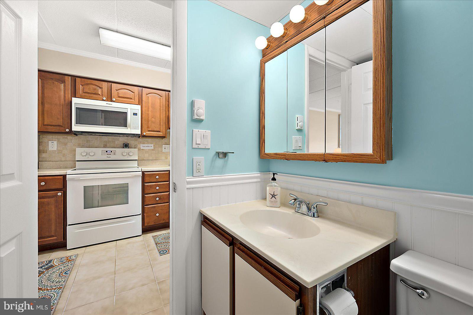 2 80th Street, Unit 504 Ocean City, MD 21842 - Photo 24 of 50 a bathroom with a sink and a microwave