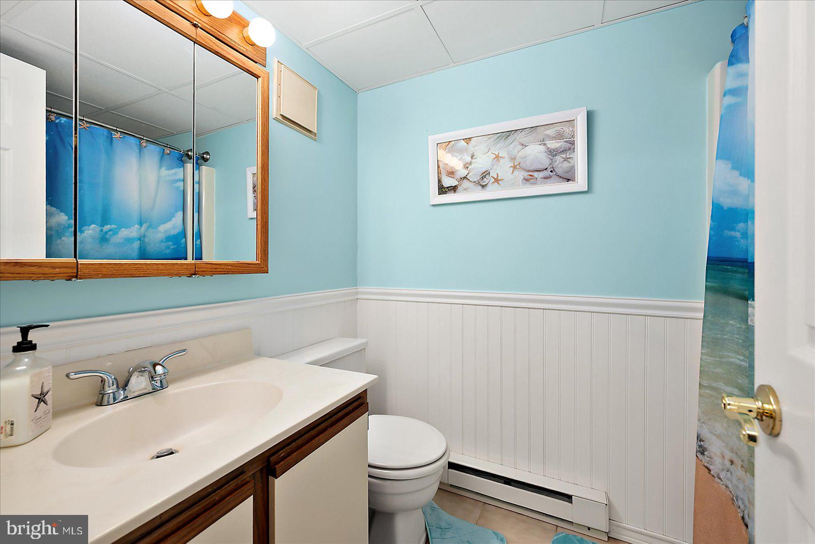 2 80th Street, Unit 504 Ocean City, MD 21842 - Photo 25 of 50 a bathroom with a sink mirror and toilet