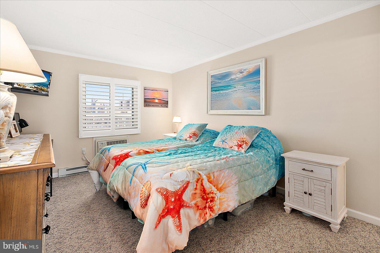 2 80th Street, Unit 504 Ocean City, MD 21842 - Photo 26 of 50 a bedroom with a bed and a window