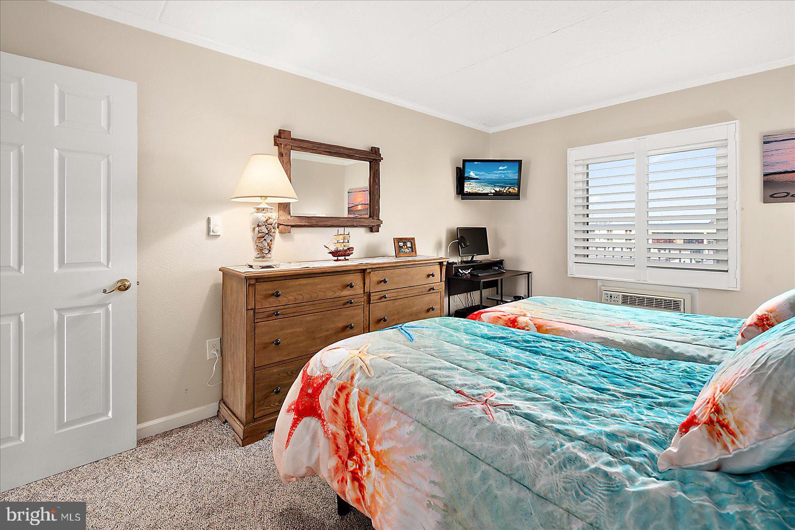 2 80th Street, Unit 504 Ocean City, MD 21842 - Photo 27 of 50 a bedroom with a bed and a window