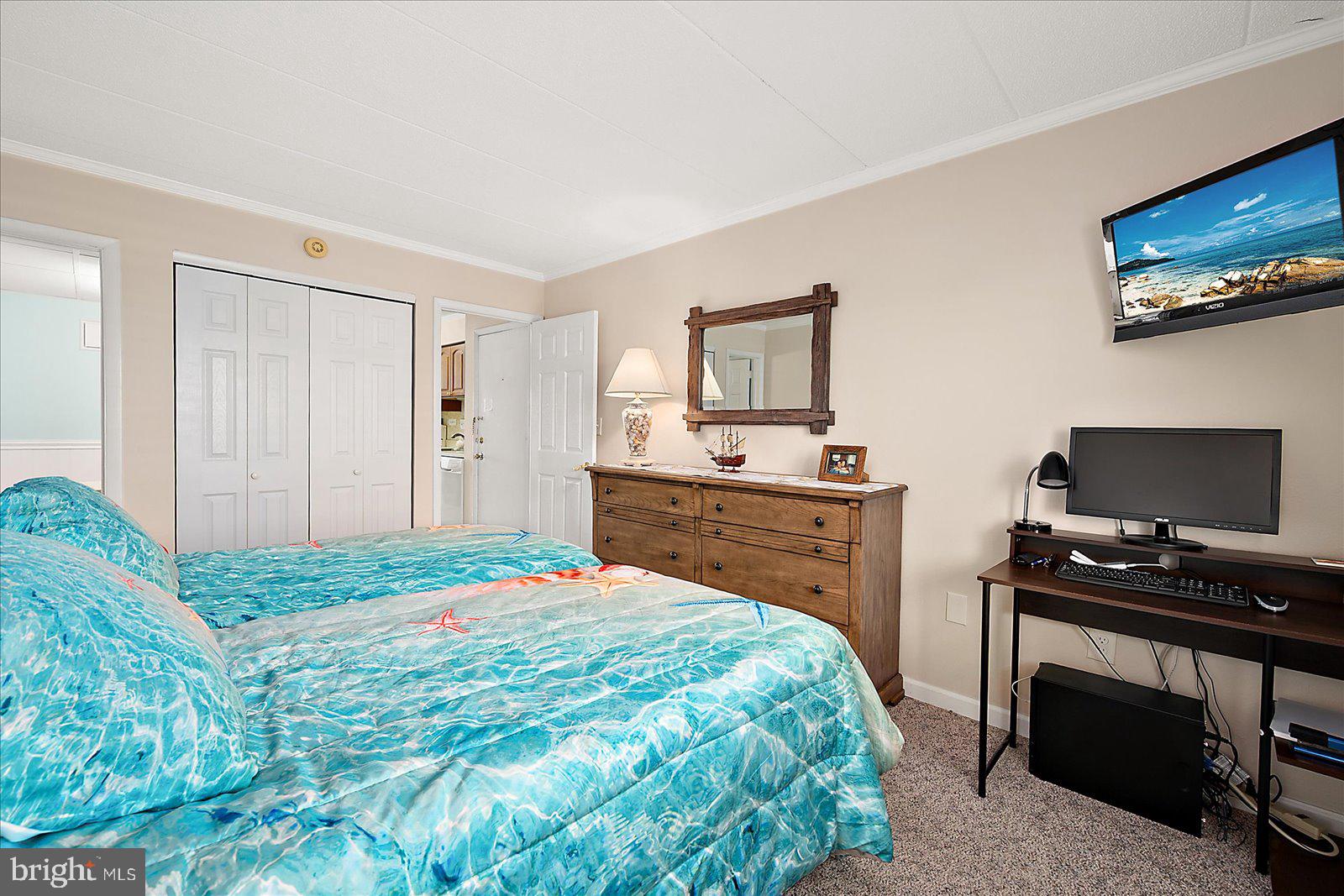 2 80th Street, Unit 504 Ocean City, MD 21842 - Photo 29 of 50 a bedroom with a bed and a flat screen tv