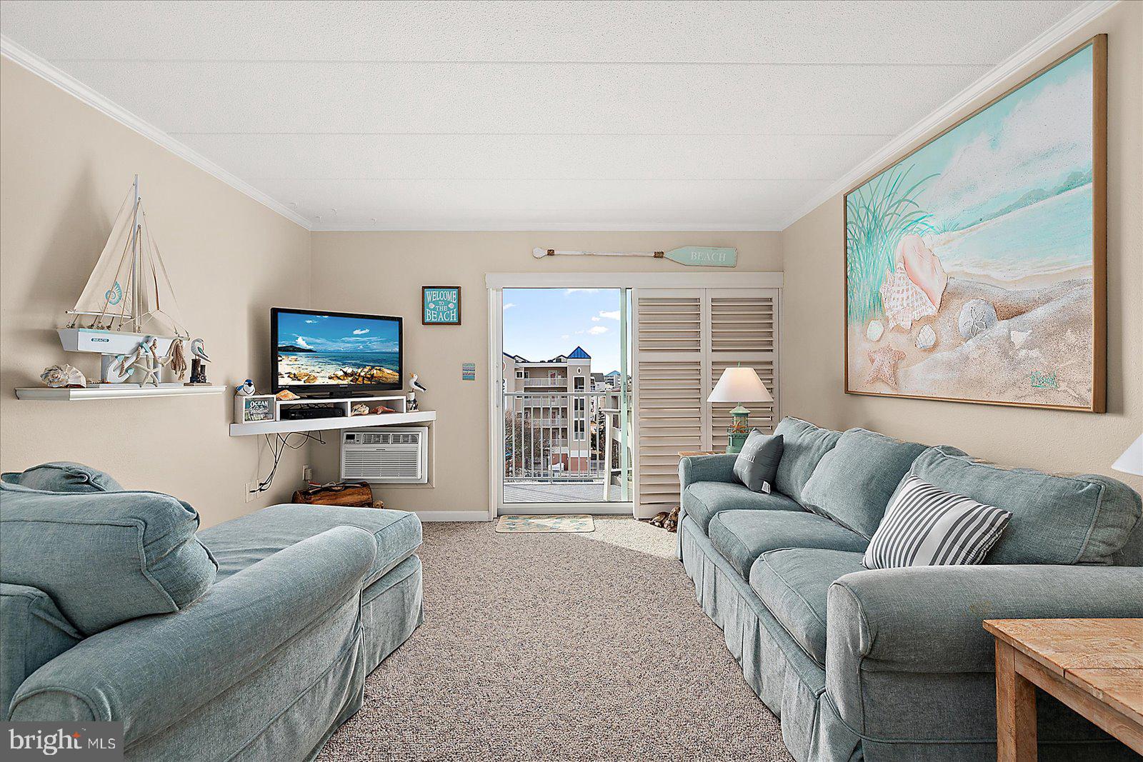 2 80th Street, Unit 504 Ocean City, MD 21842 - Photo 7 of 50 a living room with furniture and a flat screen tv