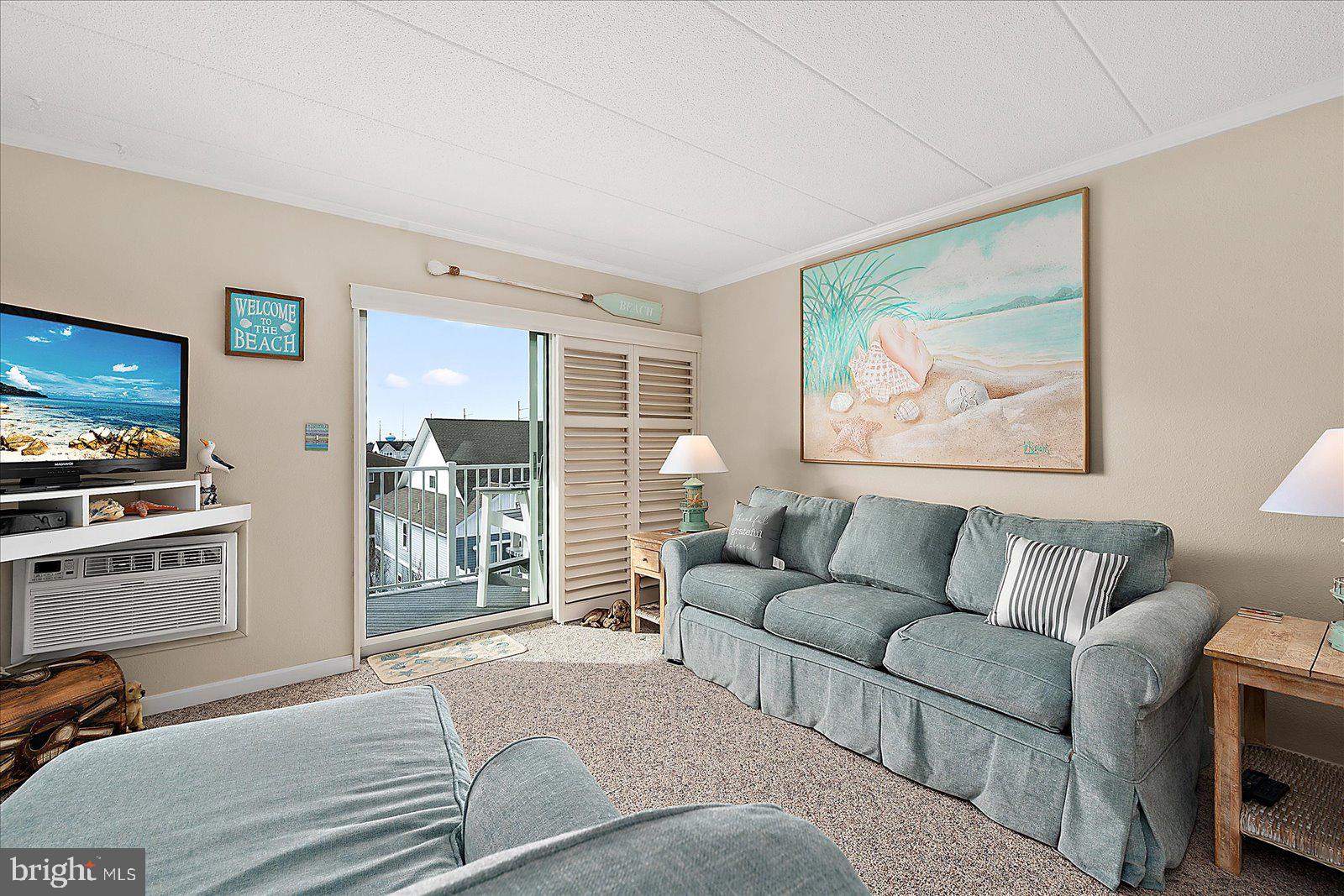 2 80th Street, Unit 504 Ocean City, MD 21842 - Photo 9 of 50 a living room with furniture and a flat screen tv