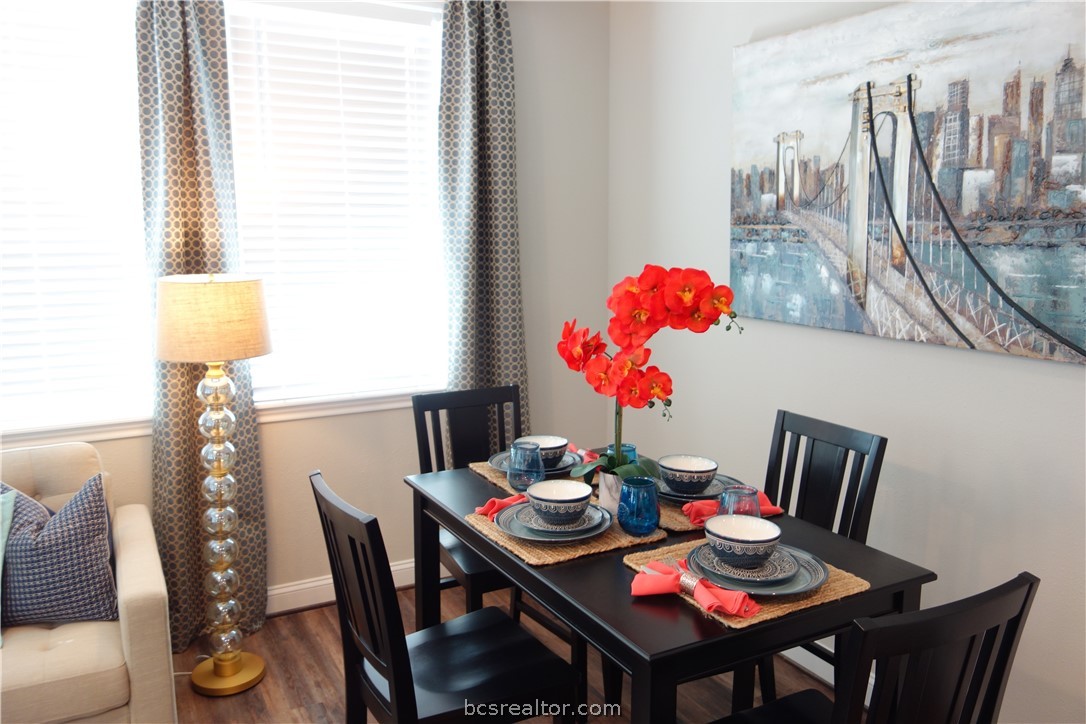 401 North Main Street, Unit 306 Bryan, TX 77803 - Photo 7 of 11 a view of a dining room with furniture and wooden floor