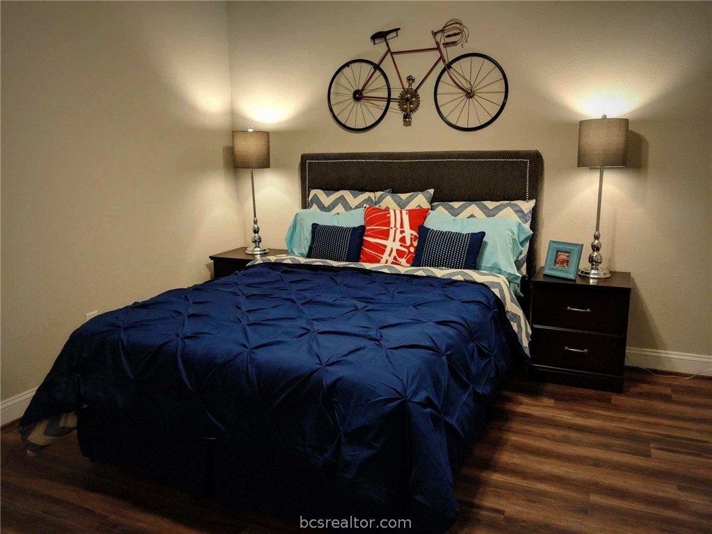 401 North Main Street, Unit 306 Bryan, TX 77803 - Photo 10 of 11 a bed sitting in a bedroom next to a lamp