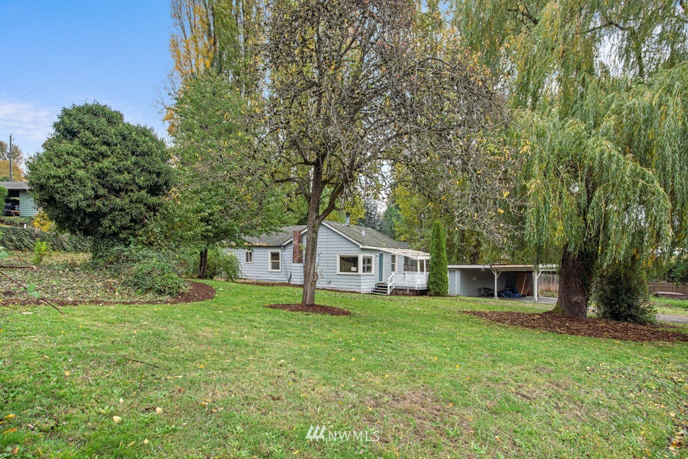 7838 South Langston Road Seattle, WA 98178 - Photo 11 of 27 a house with green field in front of it